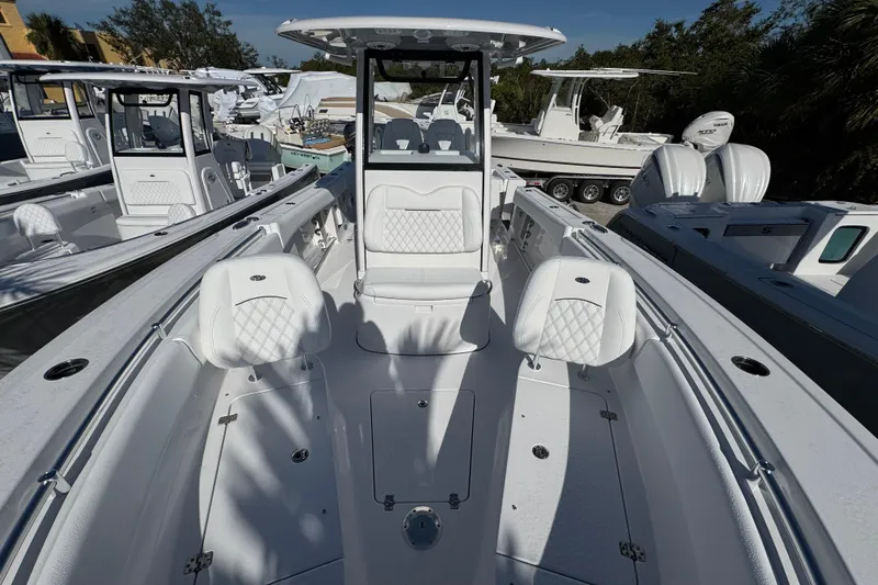  Yacht Photos Pics 2026 Sportsman Open 262 Center Console boat with white seating and sleek design.