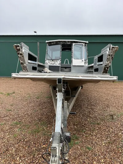 Commander Yacht Photos Pics 2014 Wooldridge 31 boat on a trailer, front view, parked on gravel.