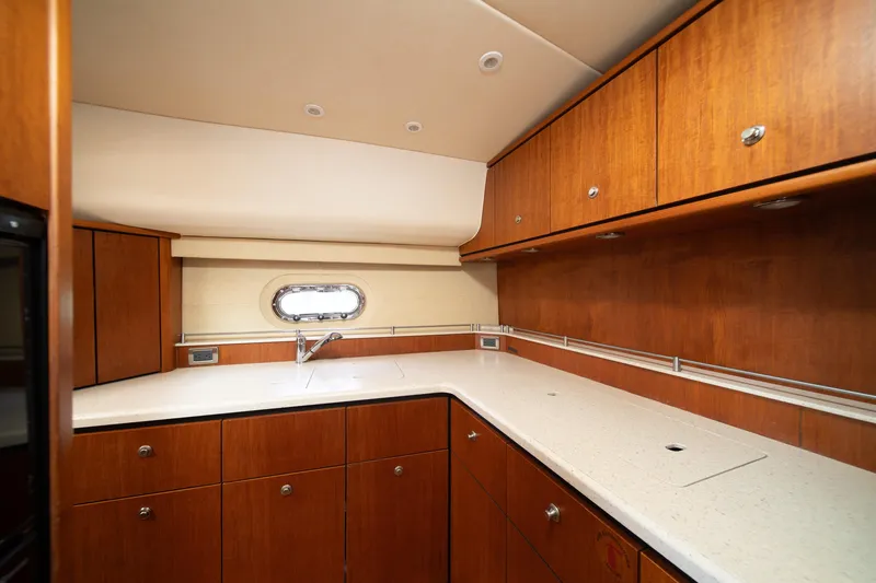  Yacht Photos Pics Luxurious 2007 Tiara Yachts 4300 Sovran kitchen with wood cabinetry and sleek countertops.