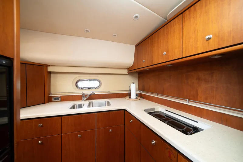  Yacht Photos Pics Luxurious 2007 Tiara Yachts 4300 Sovran kitchen with wood cabinetry and modern appliances.