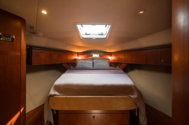 Yacht Photos Pics Luxurious cabin interior of 2007 Tiara Yachts 4300 Sovran with cozy bed and ambient lighting.