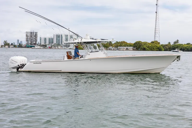 Bank Fees Yacht Photos Pics 2022 Valhalla Boatworks V-41 on water, side view with cityscape background.