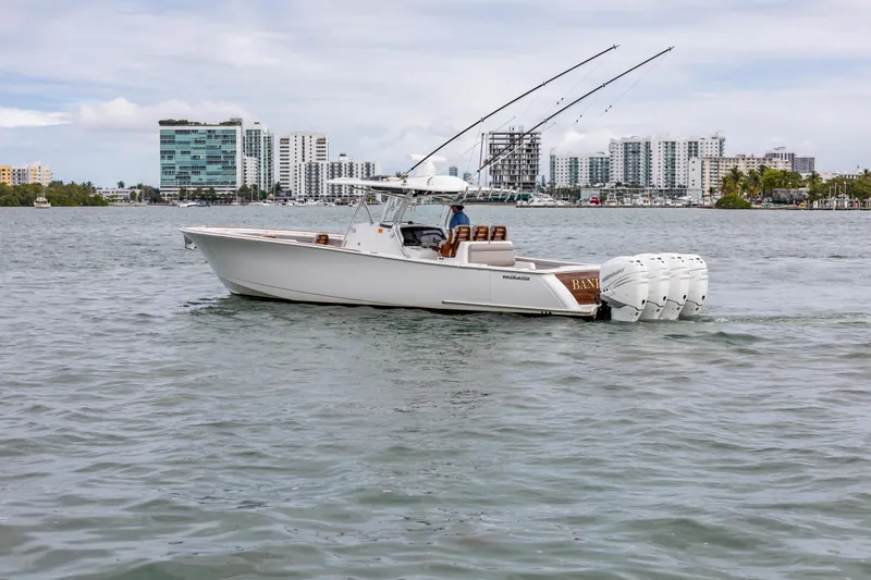Bank Fees Yacht Photos Pics 2022 Valhalla Boatworks V-41 cruising on water with cityscape background.