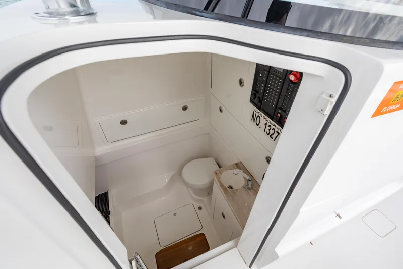 Bank Fees Yacht Photos Pics 2022 Valhalla Boatworks V-41 interior cabin with compact toilet and control panel.