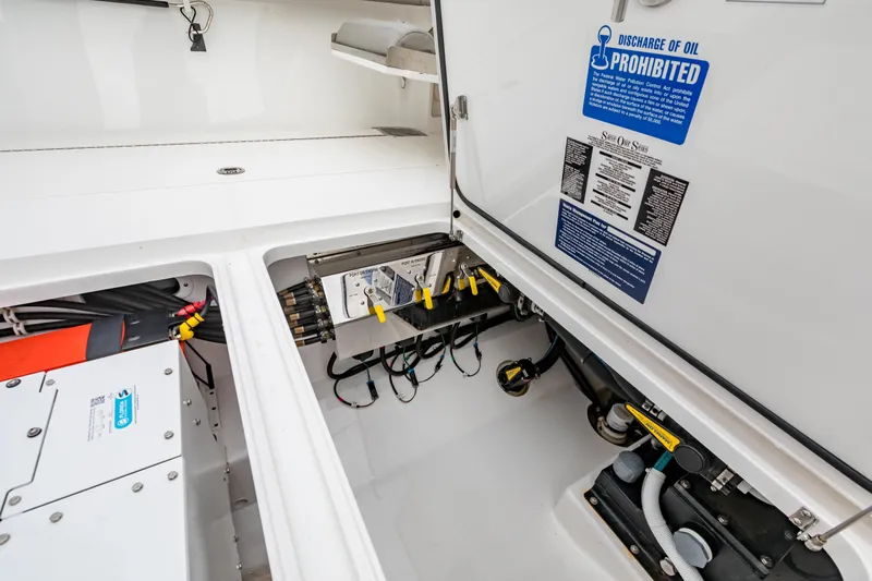 Bank Fees Yacht Photos Pics 2022 Valhalla Boatworks V-41 engine compartment with oil discharge warning sign.