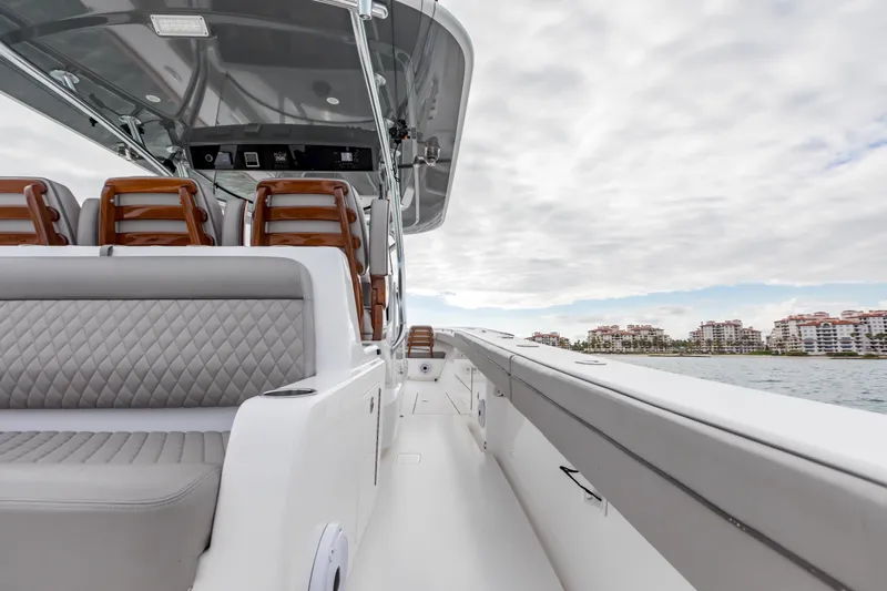 Bank Fees Yacht Photos Pics 2022 Valhalla Boatworks V-41 luxury interior with elegant seating, cruising near waterfront buildings.