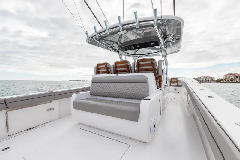 Bank Fees Yacht Photos Pics 2022 Valhalla Boatworks V-41 with sleek seating, cruising on open water under cloudy skies.