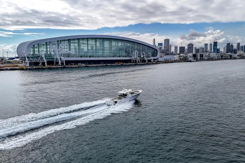Bank Fees Yacht Photos Pics 2022 Valhalla Boatworks V-41 cruising near modern waterfront cityscape.