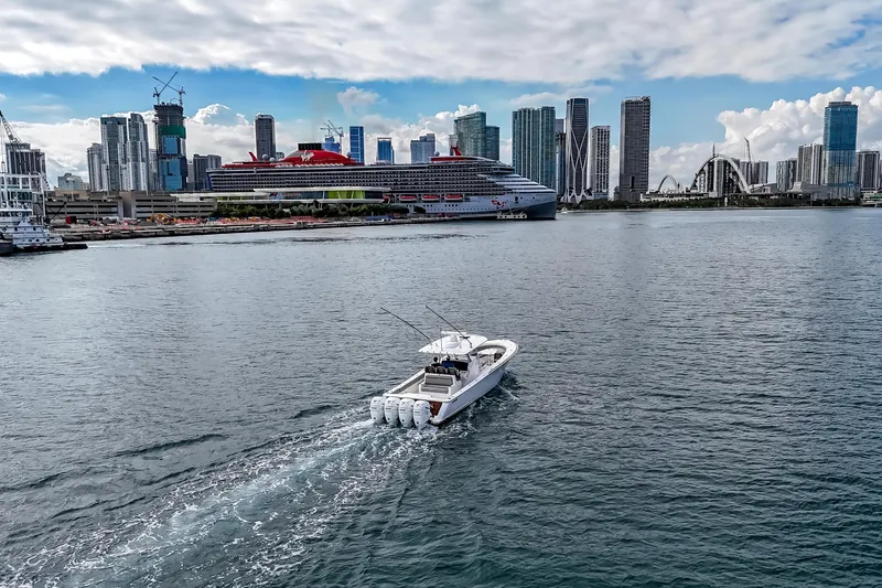 Bank Fees Yacht Photos Pics 2022 Valhalla Boatworks V-41 cruising near city skyline and large cruise ship.