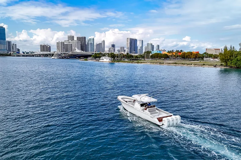 Bank Fees Yacht Photos Pics 2022 Valhalla Boatworks V-41 cruising near city skyline on a sunny day.