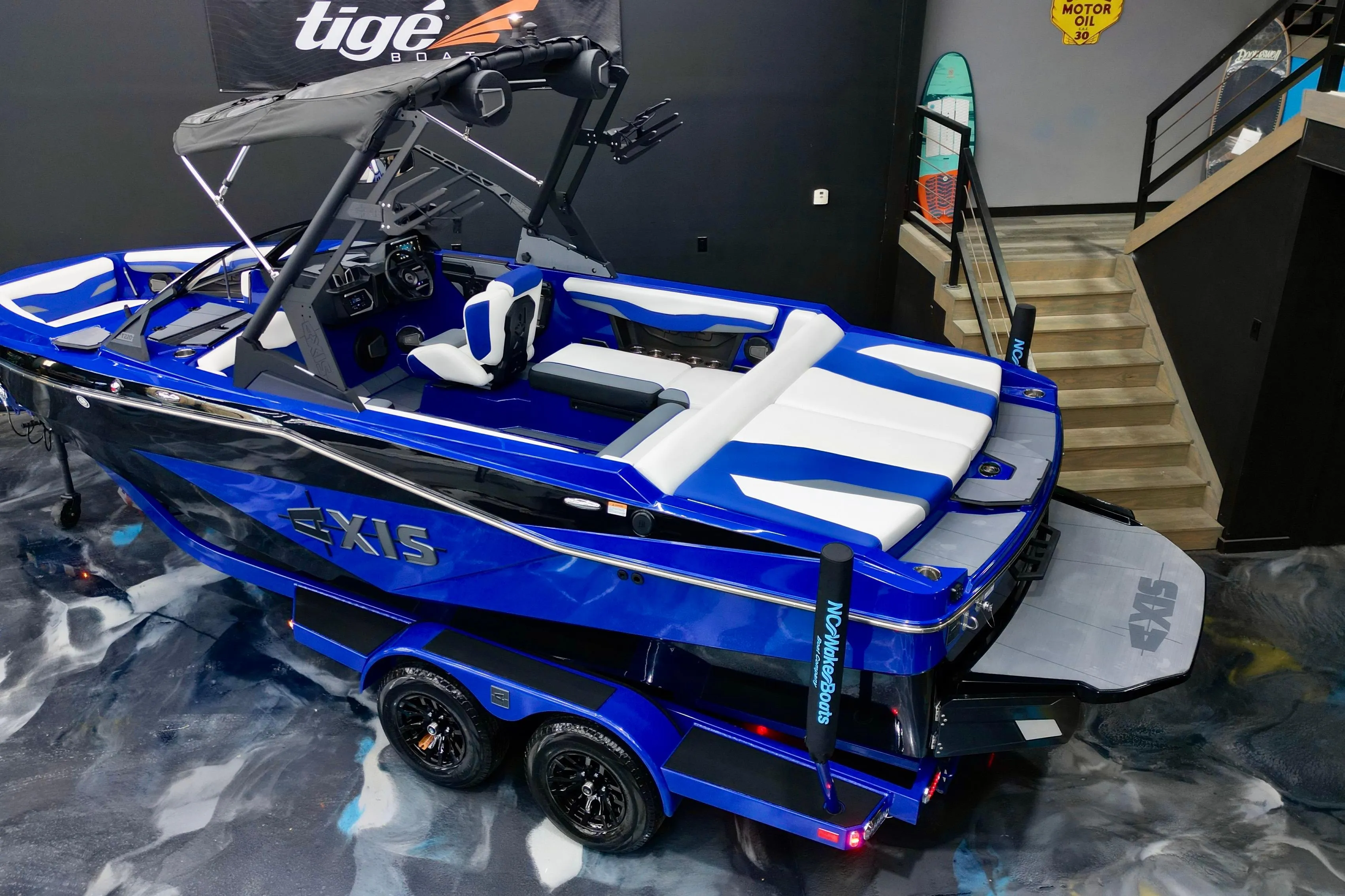 2025 Axis T220 boat in showroom, blue and white design, sleek and modern appearance.