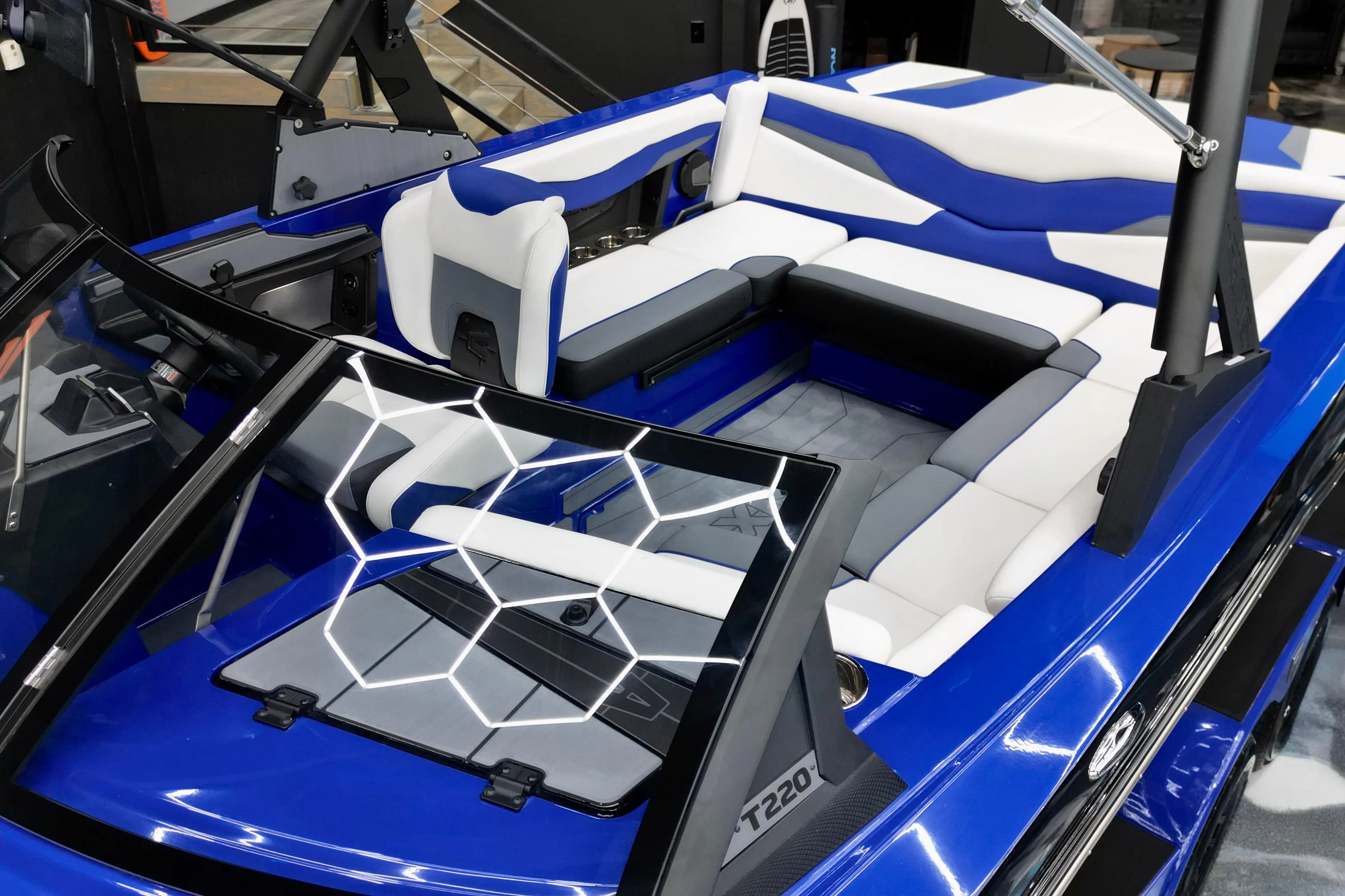 2025 Axis T220 boat interior with blue and white seating, modern design.