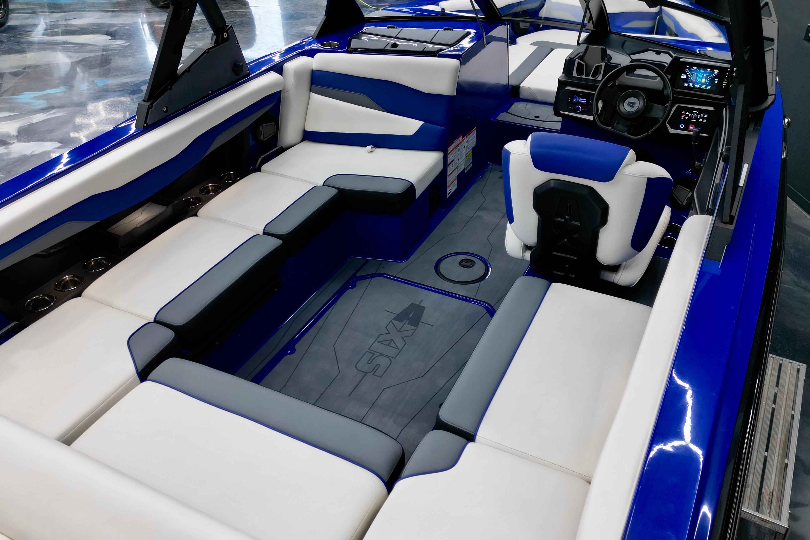 2025 Axis T220 boat interior with blue and white seating, modern dashboard, and spacious layout.