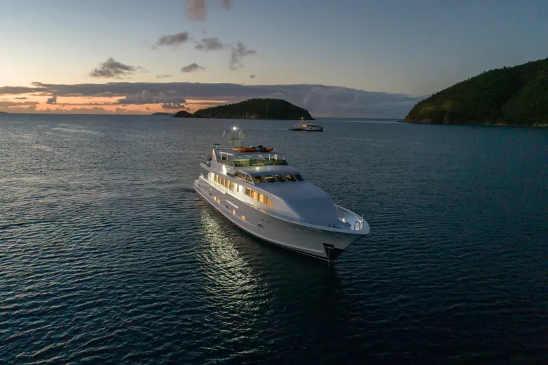  Yacht Photos Pics Luxurious 1994 Broward Marine Raised Pilothouse yacht at sunset in serene waters.