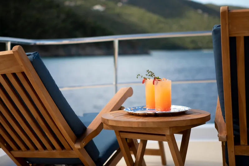  Yacht Photos Pics Wooden deck chairs and drinks on a 1994 Broward Marine Raised Pilothouse yacht.