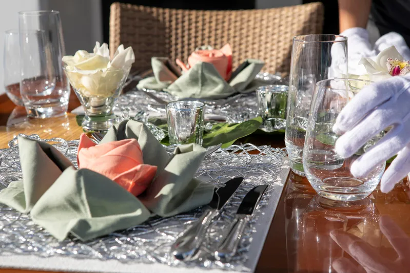  Yacht Photos Pics Elegant table setting on 1994 Broward Marine Raised Pilothouse yacht, featuring floral napkin arrangements.