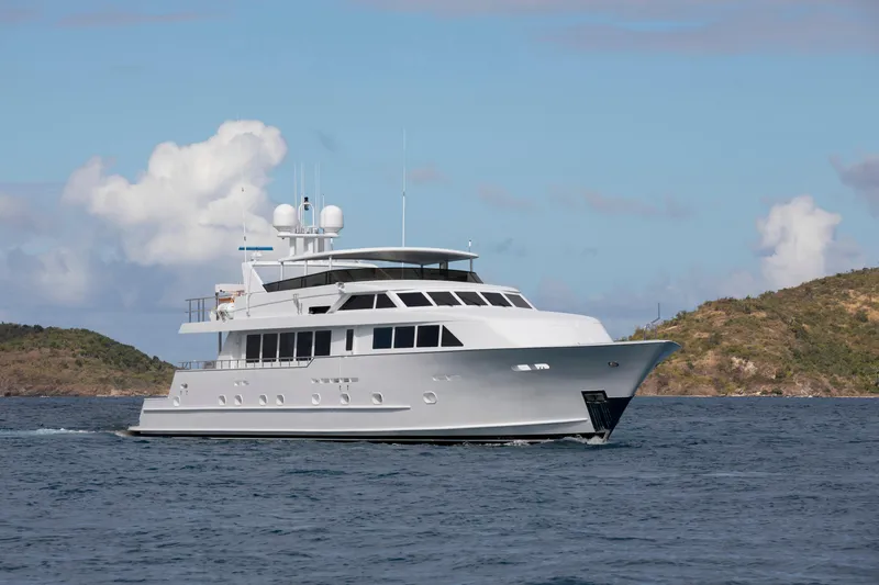  Yacht Photos Pics Luxury 1994 Broward Marine Raised Pilothouse yacht cruising near scenic islands.