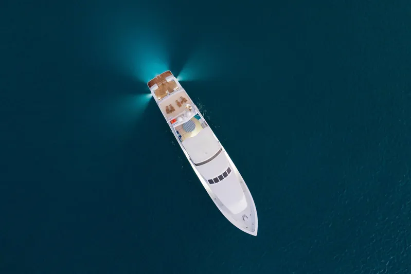  Yacht Photos Pics Aerial view of 1994 Broward Marine Raised Pilothouse yacht on calm blue water.