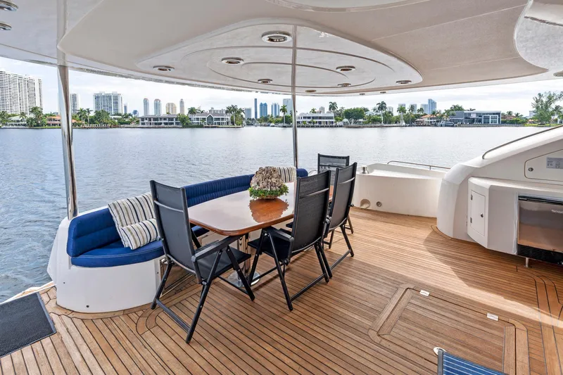 Persistence Yacht Photos Pics Luxurious 2006 Sunseeker 75 Yacht deck with elegant seating and scenic waterfront view.