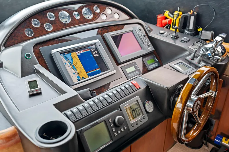 Persistence Yacht Photos Pics Control panel of a 2006 Sunseeker 75 Yacht with navigation screens and instruments.