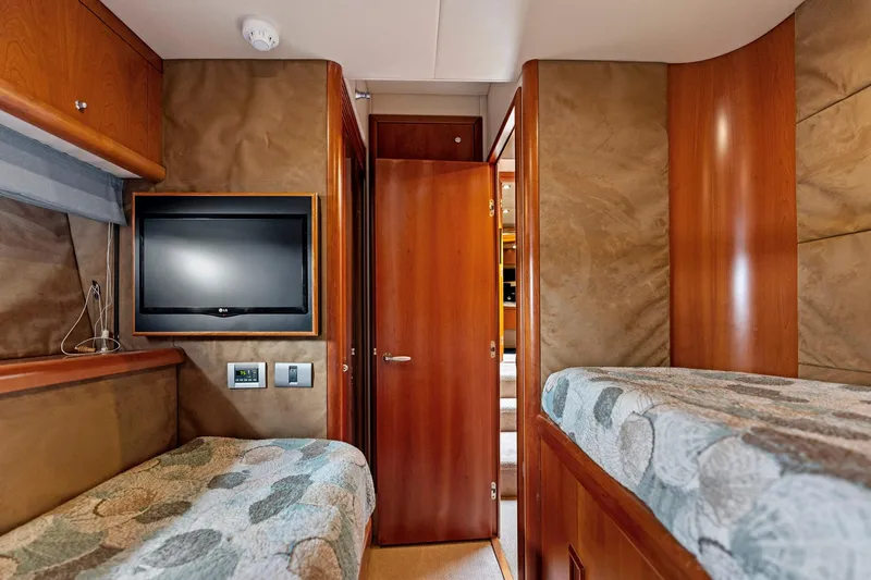 Persistence Yacht Photos Pics Luxurious cabin interior of a 2006 Sunseeker 75 Yacht with wood paneling and TV.