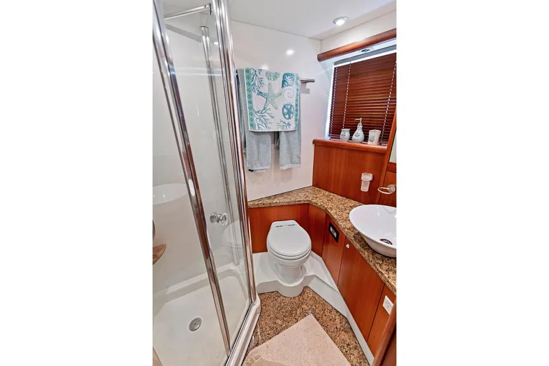 Persistence Yacht Photos Pics Luxurious bathroom in 2006 Sunseeker 75 Yacht with shower, toilet, and sink.