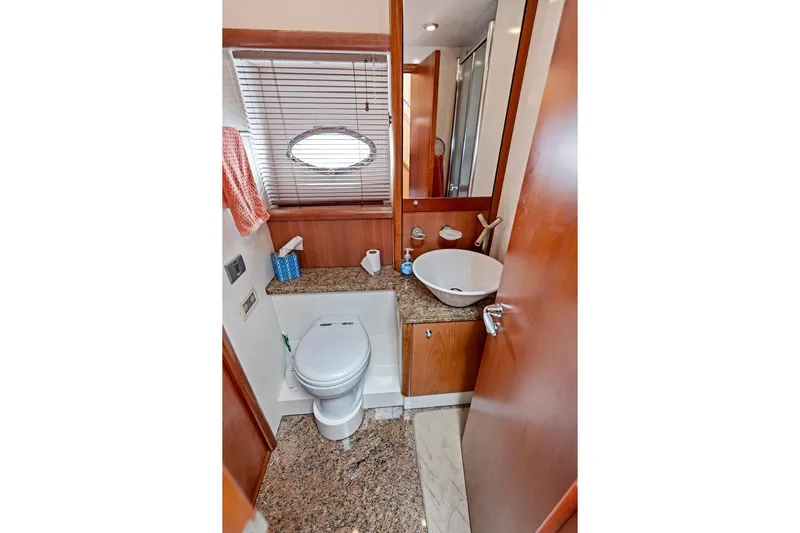 Persistence Yacht Photos Pics Luxurious bathroom in 2006 Sunseeker 75 Yacht with modern fixtures and wooden accents.