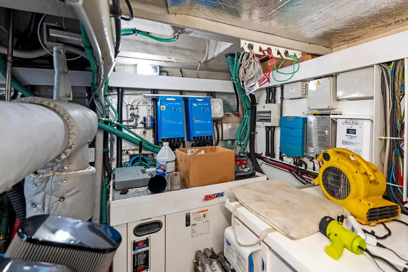 Persistence Yacht Photos Pics Engine room of a 2006 Sunseeker 75 Yacht with electrical equipment and wiring.