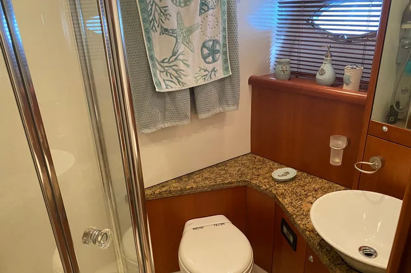 Persistence Yacht Photos Pics Luxurious bathroom in 2006 Sunseeker 75 Yacht with elegant fixtures and nautical decor.