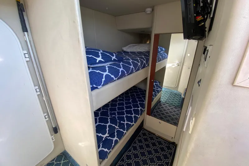 Persistence Yacht Photos Pics Bunk beds in 2006 Sunseeker 75 Yacht cabin with blue patterned bedding.