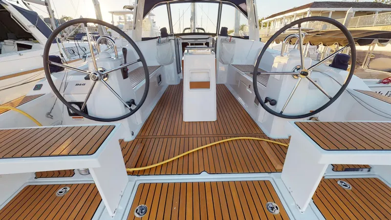 Wanderlust Yacht Photos Pics 2019 Beneteau Oceanis 38.1 yacht cockpit with dual steering wheels and teak flooring.