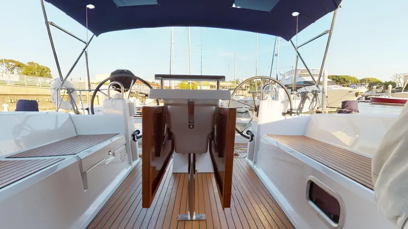 Wanderlust Yacht Photos Pics 2019 Beneteau Oceanis 38.1 yacht interior with wooden deck and dual steering wheels.