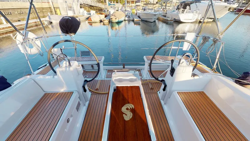 Wanderlust Yacht Photos Pics 2019 Beneteau Oceanis 38.1 yacht cockpit with dual steering wheels in marina.