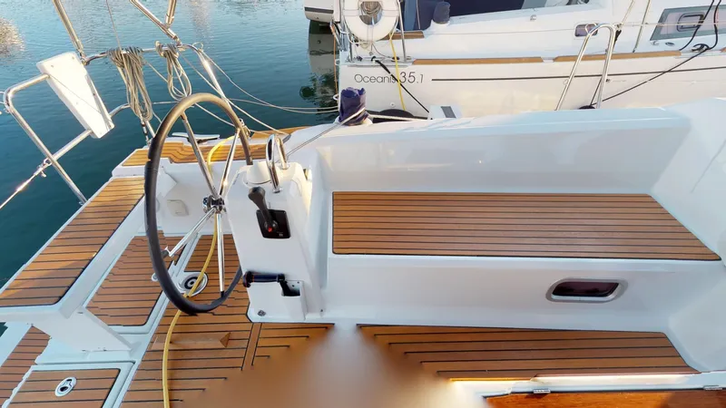 Wanderlust Yacht Photos Pics Cockpit of 2019 Beneteau Oceanis 38.1 sailboat with wooden deck and steering wheel.