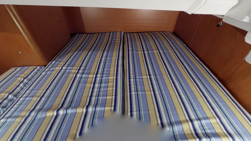 Wanderlust Yacht Photos Pics Cabin interior of 2019 Beneteau Oceanis 38.1 with striped bedding.