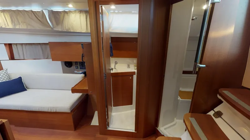 Wanderlust Yacht Photos Pics Interior of 2019 Beneteau Oceanis 38.1 yacht, featuring cozy seating and compact bathroom.