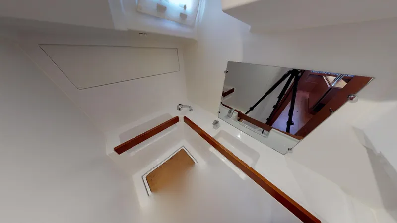 Wanderlust Yacht Photos Pics Interior of 2019 Beneteau Oceanis 38.1 yacht, featuring sleek white design and mirror.