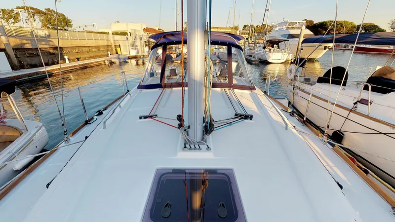 Wanderlust Yacht Photos Pics 2019 Beneteau Oceanis 38.1 sailboat docked in a marina, showcasing deck and mast.
