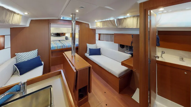 Wanderlust Yacht Photos Pics Interior of 2019 Beneteau Oceanis 38.1 yacht, featuring modern wood finish and cozy seating.