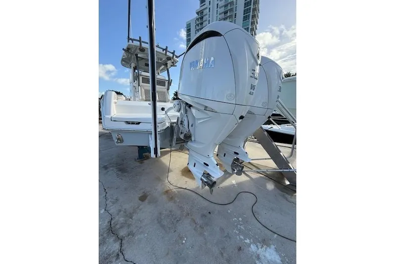  Yacht Photos Pics 2025 Solace 28HCS boat with dual Yamaha outboard engines, docked under a clear sky.