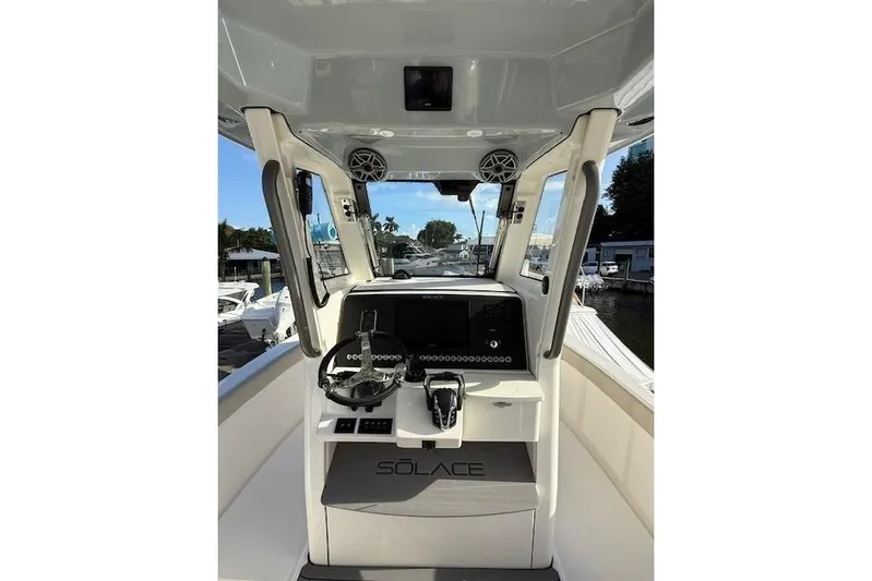  Yacht Photos Pics 2025 Solace 28HCS boat helm with modern controls and steering wheel.
