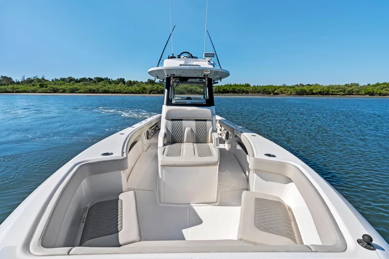  Yacht Photos Pics 2025 Solace 32 CS boat cruising on a calm lake under clear blue skies.