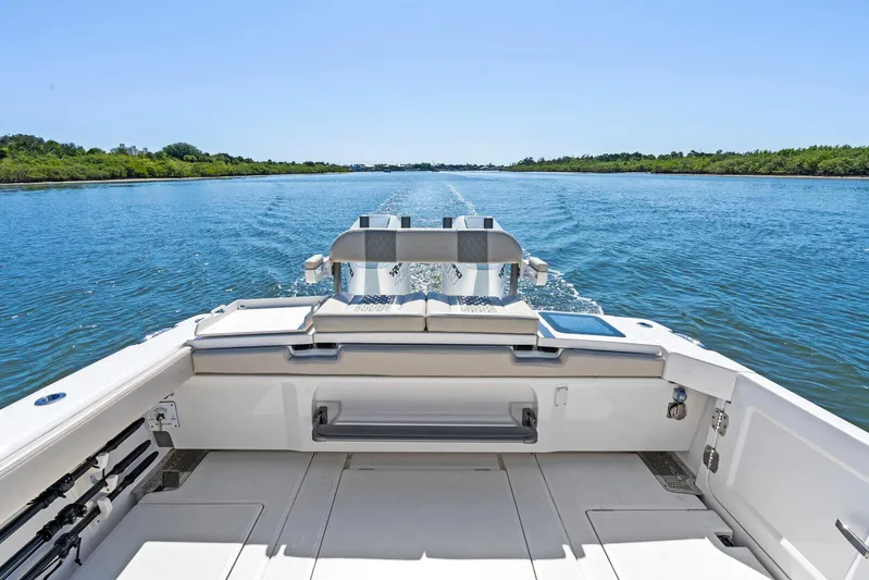  Yacht Photos Pics 2025 Solace 32 CS boat cruising on a serene waterway, surrounded by lush greenery.