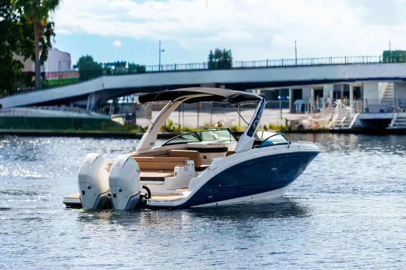  Yacht Photos Pics Luxury Sea Ray boat cruising on a sunny day near a bridge.