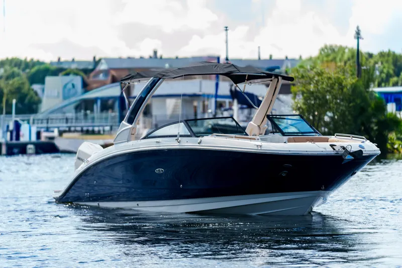  Yacht Photos Pics Luxury Sea Ray boat cruising on a calm river near a marina.