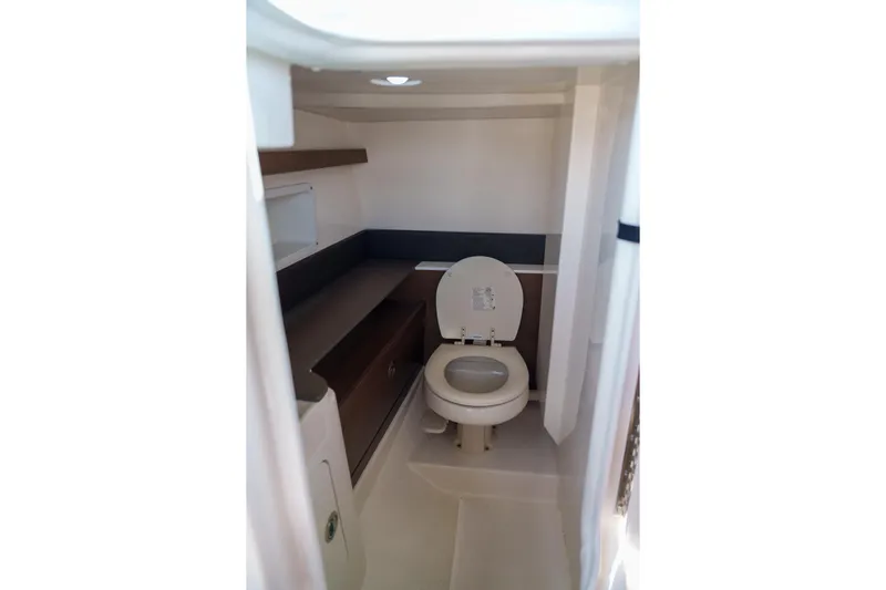  Yacht Photos Pics Sea Ray boat interior with compact marine toilet and storage shelves.