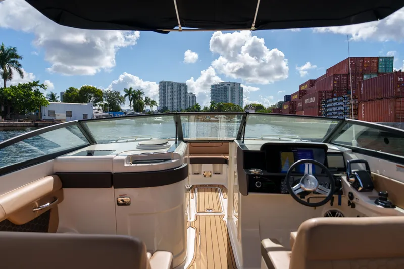  Yacht Photos Pics Interior view of a Sea Ray boat with a scenic waterfront backdrop.