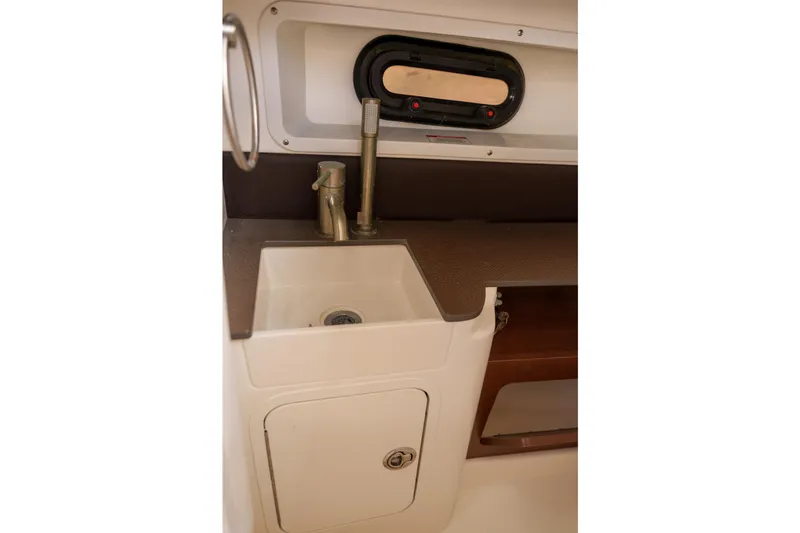  Yacht Photos Pics Sea Ray boat interior sink with faucet and storage compartment.