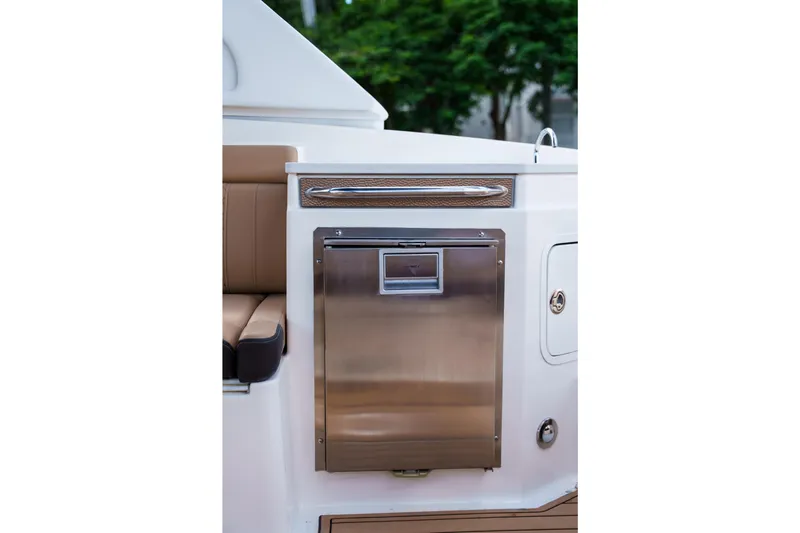 Yacht Photos Pics Stainless steel refrigerator on a Sea Ray boat with brown seating and white paneling.