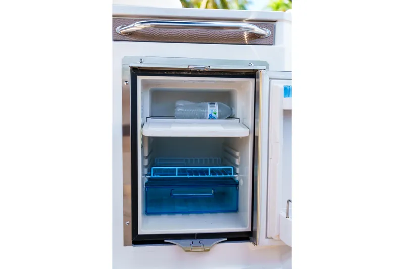  Yacht Photos Pics Open mini fridge on Sea Ray boat with water bottle inside.